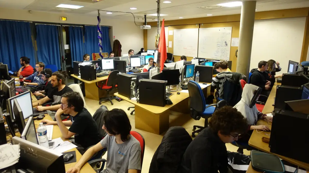 Developers working at rows of desktop PCs during Global Game Jam 2019 in Arles, France