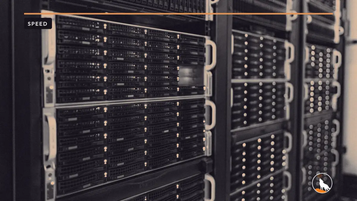 Server racks in the NOIRLab headquarters computer room in Tucson, graded navy and orange, with the wolf mark.