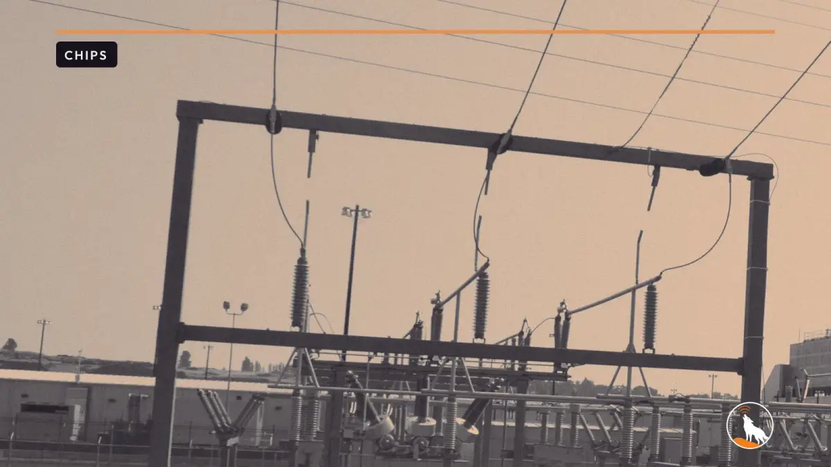 Cooling towers at the Google data center in The Dalles, Oregon, graded navy and orange, with the wolf mark.