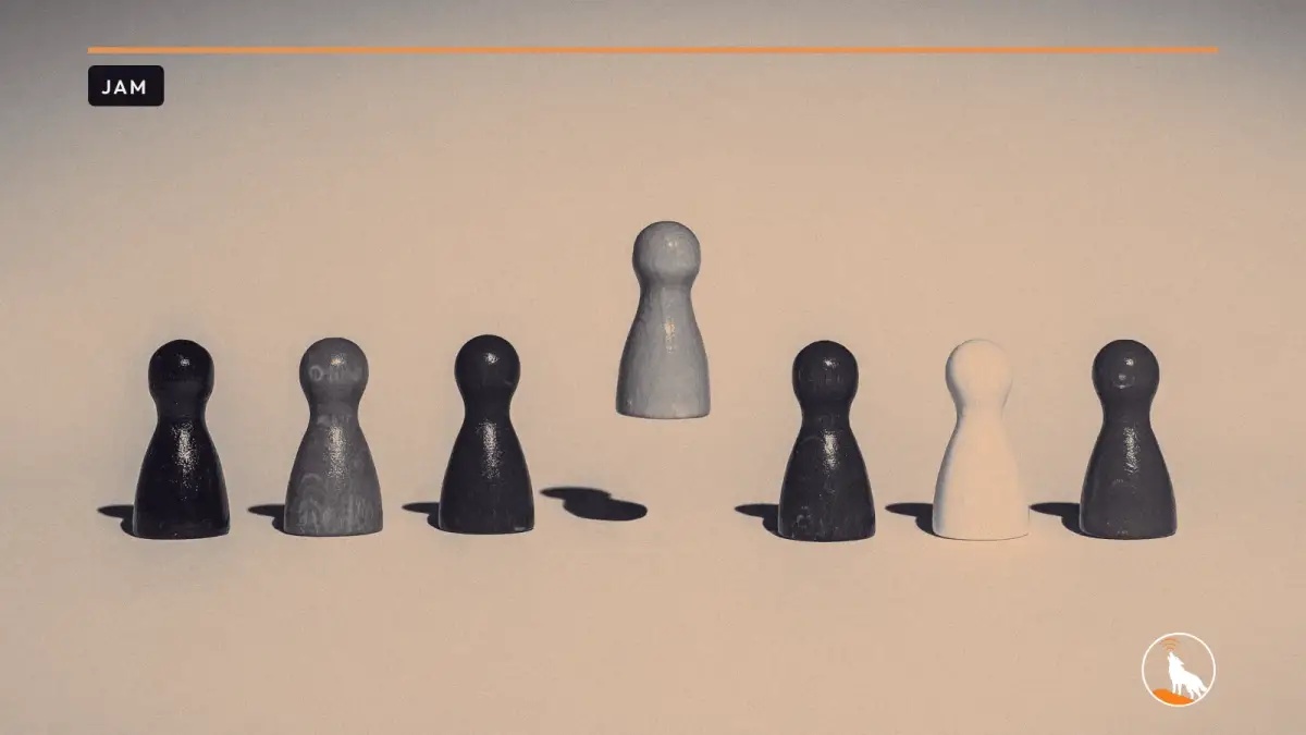 A row of colorful wooden game pawns on a plain white surface, with an orange pawn hovering above the others.
