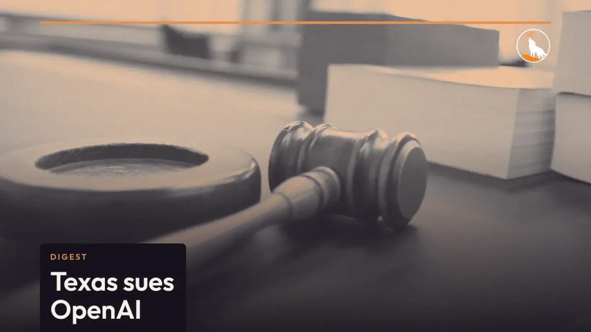 A wooden judge's gavel resting beside its sound block on a courtroom bench, with stacks of thick books behind it.